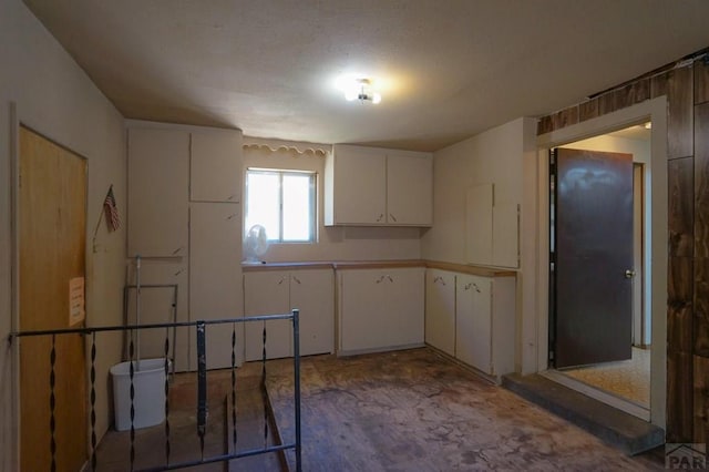 kitchen with light countertops and white cabinets