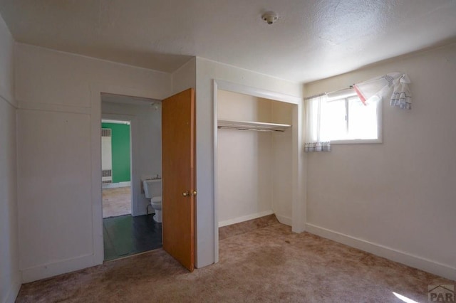 1021 7th St, Walsenburg, CO 81089 - unfurnished bedroom with light carpet, a closet, and baseboards