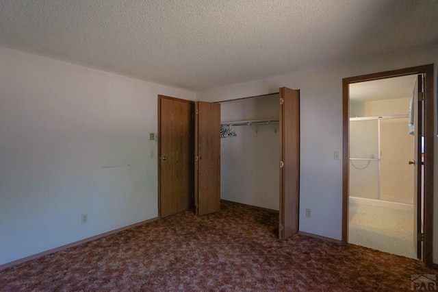 unfurnished bedroom featuring a textured ceiling, a closet, carpet, and baseboards