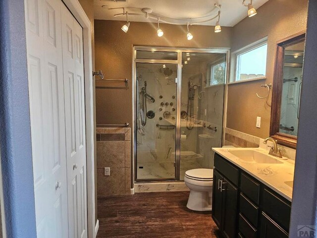 full bath featuring toilet, a closet, a sink, and tile walls