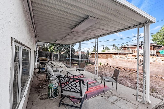 36 Loyola Ln, Pueblo, CO 81005 - fenced backyard with a trampoline and a patio