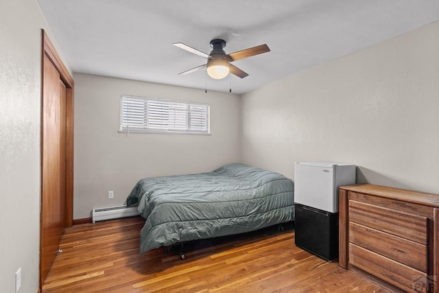 36 Loyola Ln, Pueblo, CO 81005 - bedroom with a baseboard heating unit, light wood-type flooring, a closet, and a ceiling fan