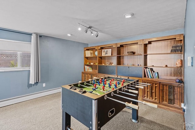 36 Loyola Ln, Pueblo, CO 81005 - rec room with carpet floors and a baseboard heating unit
