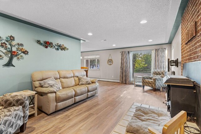 36 Loyola Ln, Pueblo, CO 81005 - living area with a textured ceiling, light wood-type flooring, baseboard heating, and recessed lighting
