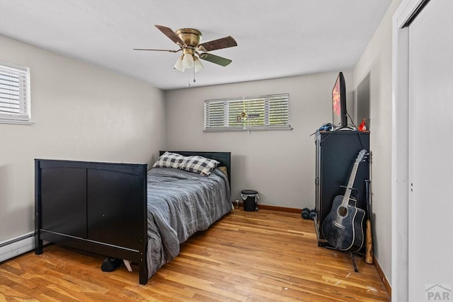 36 Loyola Ln, Pueblo, CO 81005 - bedroom with wood finished floors, baseboards, a baseboard radiator, and ceiling fan