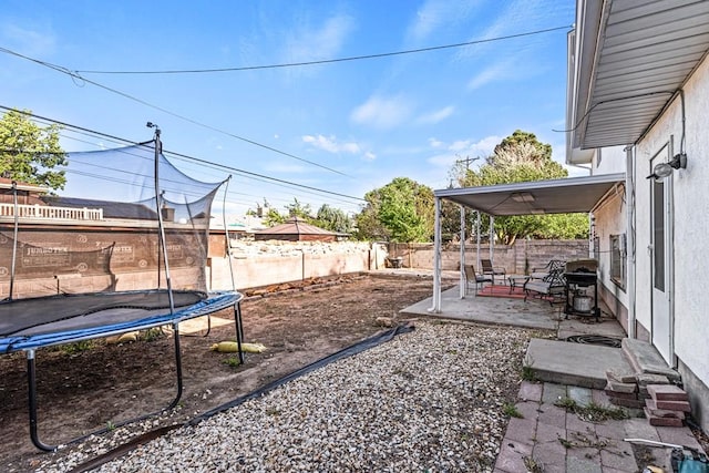 36 Loyola Ln, Pueblo, CO 81005 - fenced backyard with a trampoline and a patio area