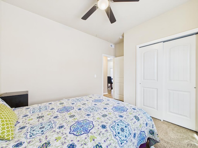 bedroom with a ceiling fan, visible vents, and a closet