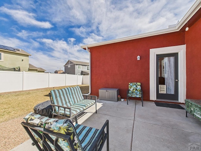 view of patio with an outdoor living space and fence