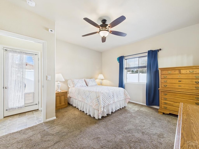 carpeted bedroom featuring baseboards and a ceiling fan