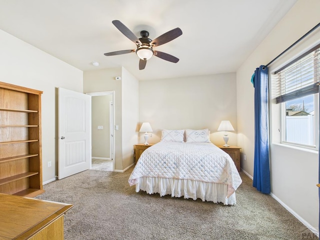 carpeted bedroom featuring a ceiling fan and baseboards