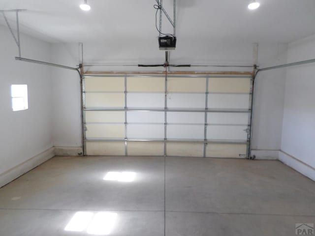 garage featuring baseboards and a garage door opener