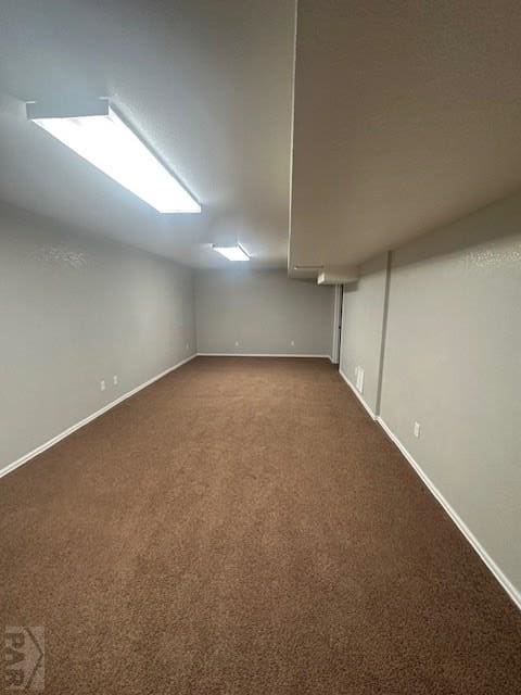 662 S Bayfield Ave, Pueblo West, CO 81007 - additional living space featuring dark colored carpet, baseboards, and lofted ceiling