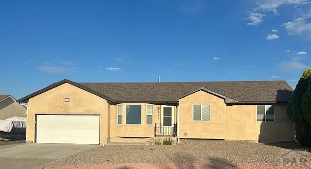 662 S Bayfield Ave, Pueblo West, CO 81007 - ranch-style house featuring concrete driveway, a garage, and stucco siding