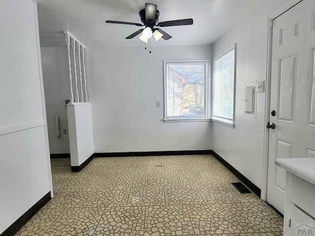 spare room featuring light floors, visible vents, baseboards, and ceiling fan