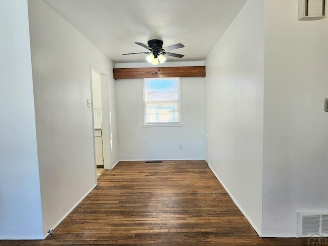 unfurnished room featuring ceiling fan, dark wood-type flooring, and visible vents