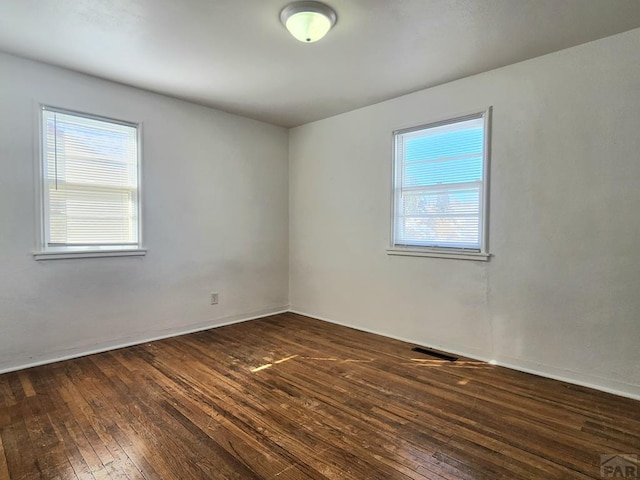 empty room featuring dark wood-style floors