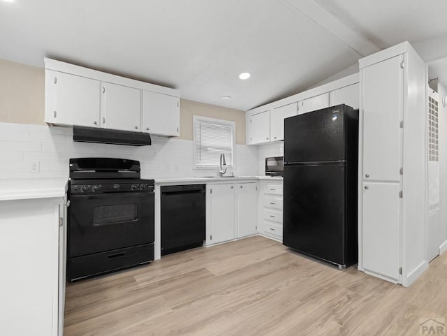 353 E Byrd Dr, Pueblo West, CO 81007 - kitchen featuring black appliances, under cabinet range hood, light countertops, light wood-type flooring, and tasteful backsplash