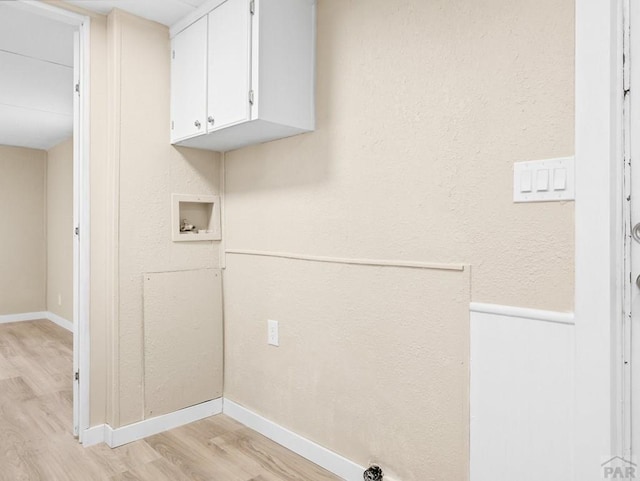 353 E Byrd Dr, Pueblo West, CO 81007 - laundry area featuring light wood-style flooring, washer hookup, and cabinet space