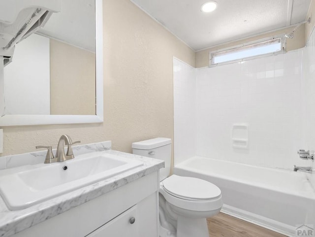 353 E Byrd Dr, Pueblo West, CO 81007 - bathroom with vanity, washtub / shower combination, wood finished floors, and a textured wall