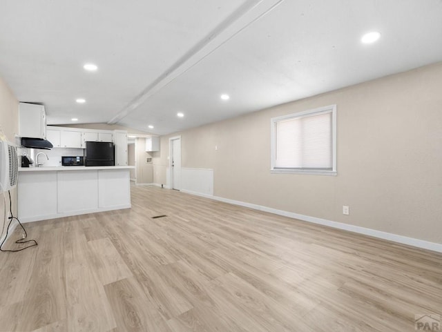 353 E Byrd Dr, Pueblo West, CO 81007 - unfurnished living room featuring light wood finished floors, vaulted ceiling, and recessed lighting