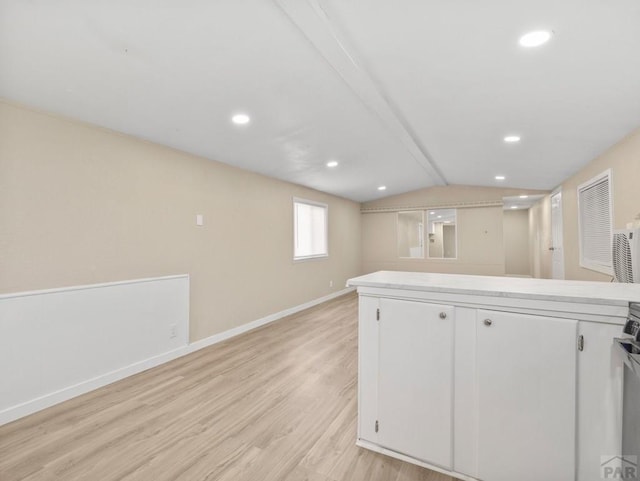 353 E Byrd Dr, Pueblo West, CO 81007 - kitchen featuring light wood finished floors, vaulted ceiling, light countertops, white cabinetry, and recessed lighting