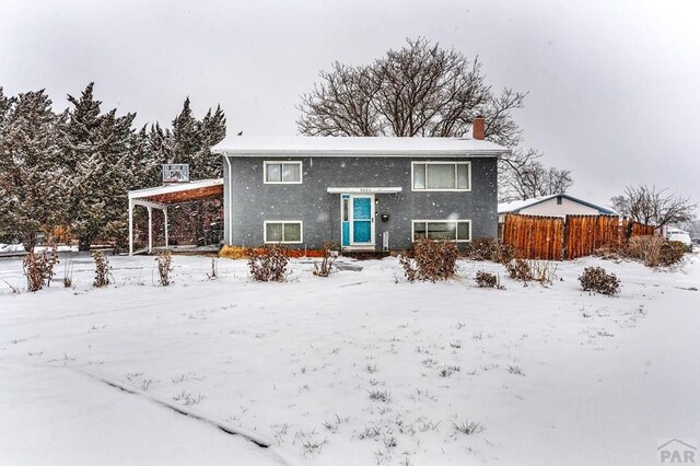 view of front of house featuring fence and stucco siding