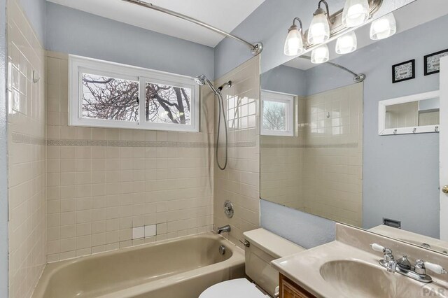 bathroom with  shower combination, vanity, and toilet