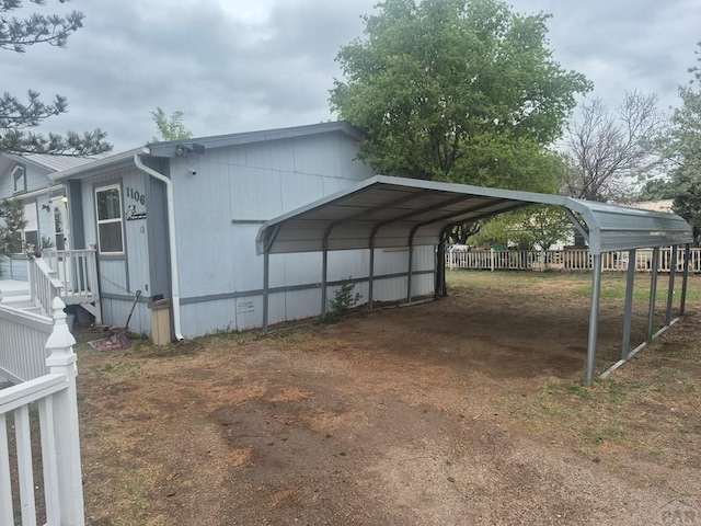 1106 10th St, Las Animas, CO 81054 - view of property exterior featuring a detached carport and driveway