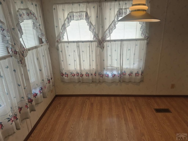 1106 10th St, Las Animas, CO 81054 - detailed view of wood finished floors and wallpapered walls