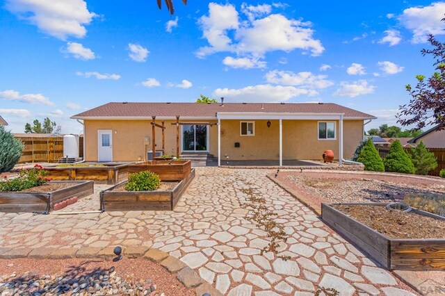 853 S Blakeland Dr, Pueblo West, CO 81007 - rear view of property with a garden, a patio, and stucco siding