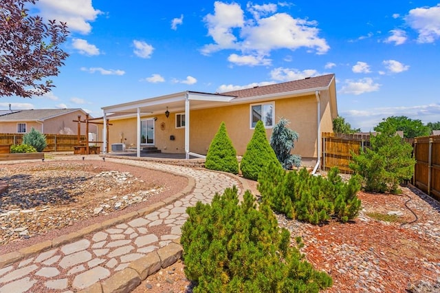 853 S Blakeland Dr, Pueblo West, CO 81007 - view of front of home with stucco siding, a patio, and a fenced backyard