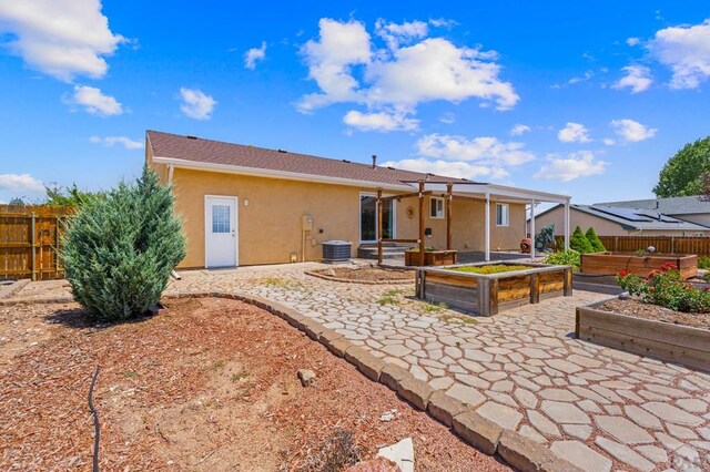 853 S Blakeland Dr, Pueblo West, CO 81007 - back of house featuring a garden, a patio, and stucco siding