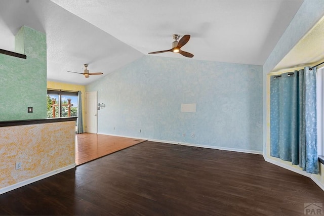 853 S Blakeland Dr, Pueblo West, CO 81007 - unfurnished living room with a ceiling fan, vaulted ceiling, wood finished floors, and wallpapered walls