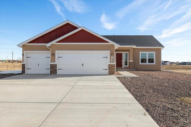 craftsman house with a garage, concrete driveway, stone siding, board and batten siding, and stucco siding