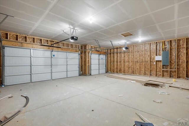 garage featuring electric panel and a garage door opener