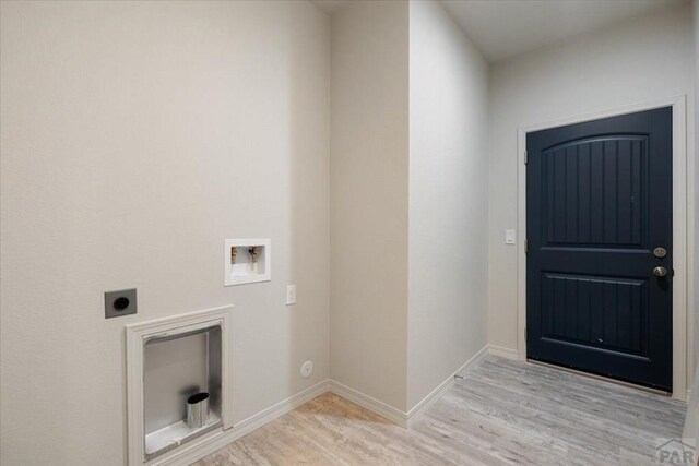 washroom featuring laundry area, baseboards, hookup for a washing machine, light wood-type flooring, and electric dryer hookup