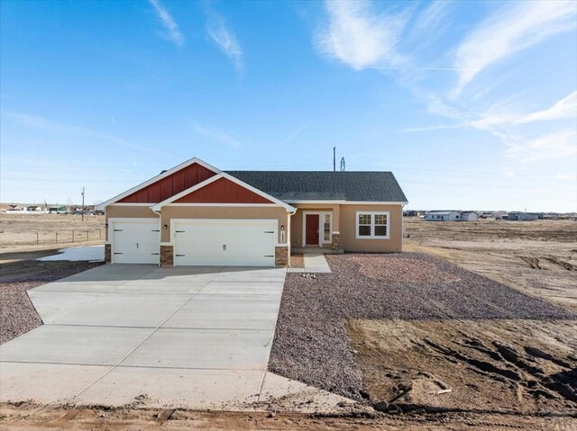 view of front facade with a garage, concrete driveway, a shingled roof, and board and batten siding