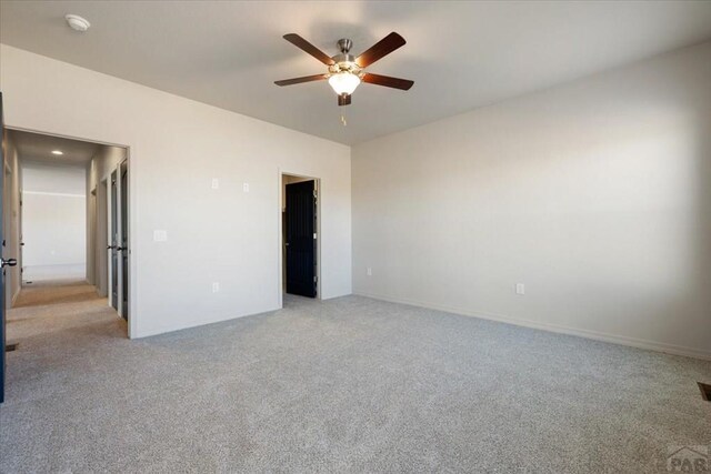 unfurnished bedroom with a ceiling fan, light carpet, and visible vents