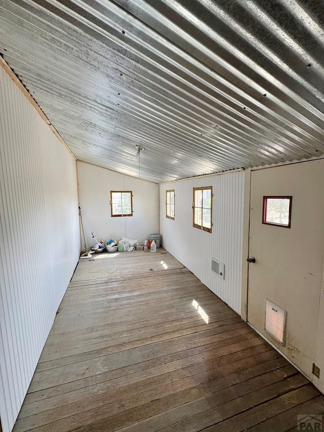 basement with wood-type flooring and visible vents