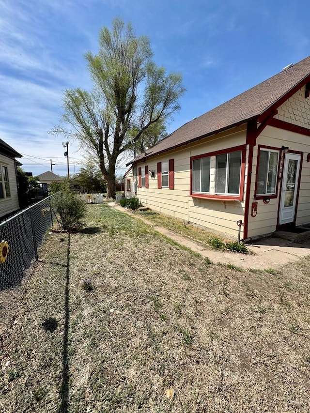 view of side of home with fence