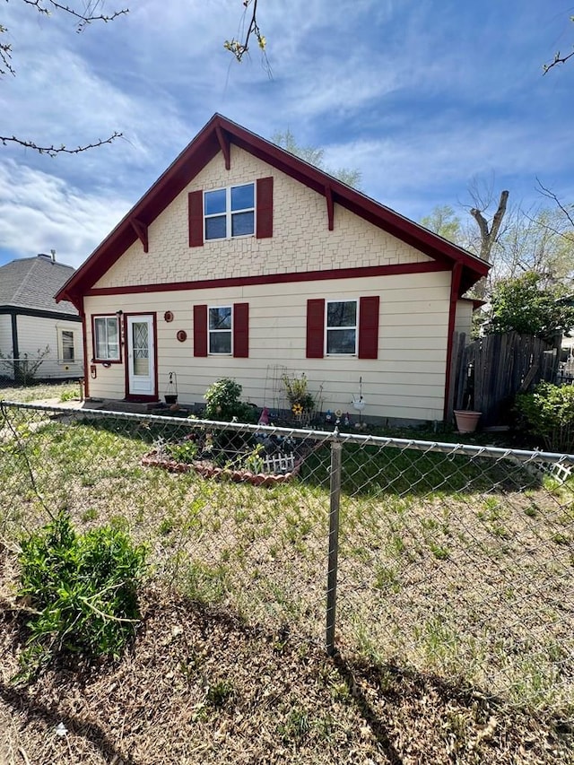 bungalow-style home with fence