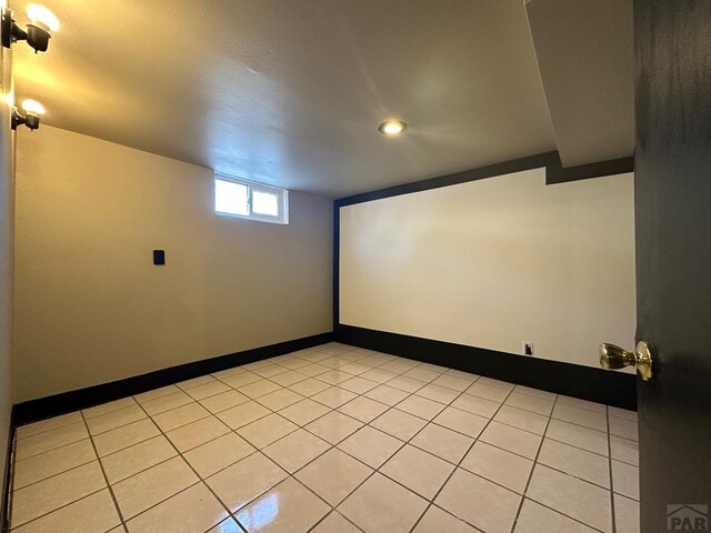 interior space with light tile patterned floors and baseboards