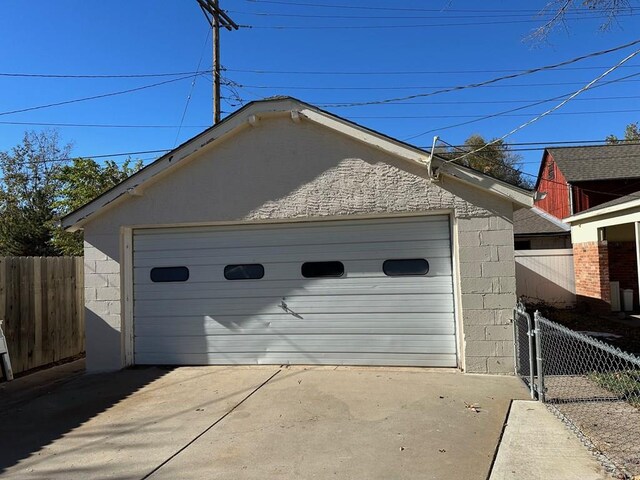 detached garage featuring fence