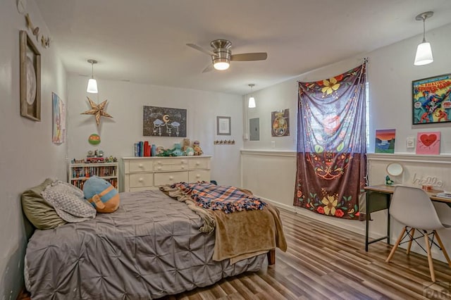 180 Welton Ave, Walsenburg, CO 81089 - bedroom with wood finished floors, an office area, electric panel, and a ceiling fan