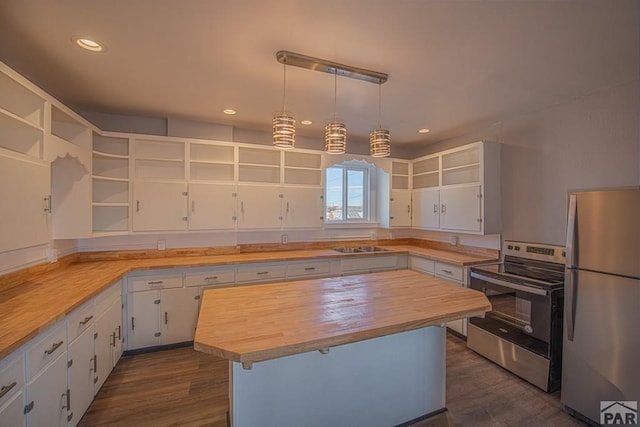 901 E C St, Pueblo, CO 81003 - kitchen with stainless steel appliances, butcher block counters, white cabinets, open shelves, and pendant lighting