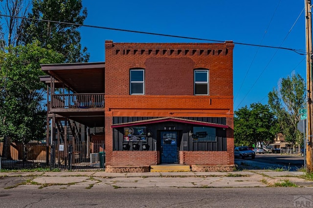901 E C St, Pueblo, CO 81003 - view of front of home with brick siding, fence, and stairs