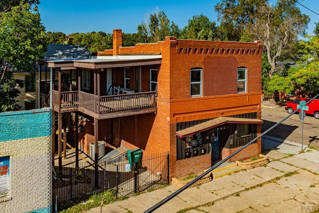 exterior space with brick siding and fence