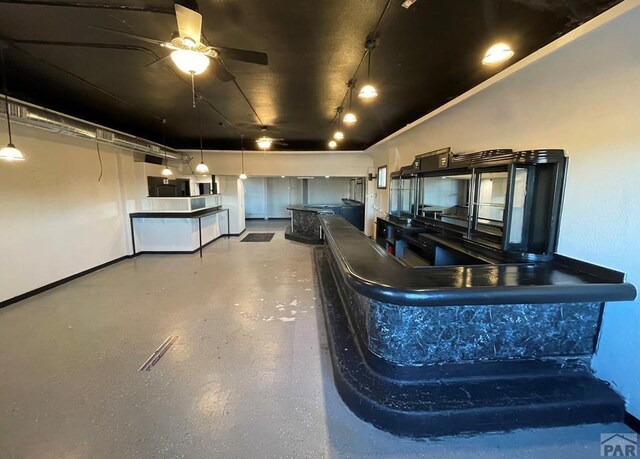 901 E C St, Pueblo, CO 81003 - kitchen featuring dark countertops and ceiling fan