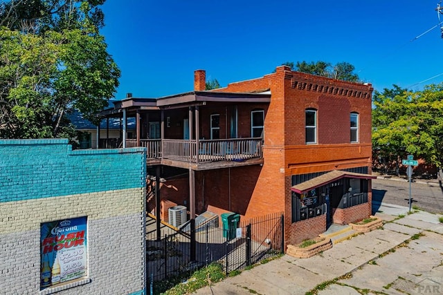 901 E C St, Pueblo, CO 81003 - exterior space with a chimney, fence, and brick siding