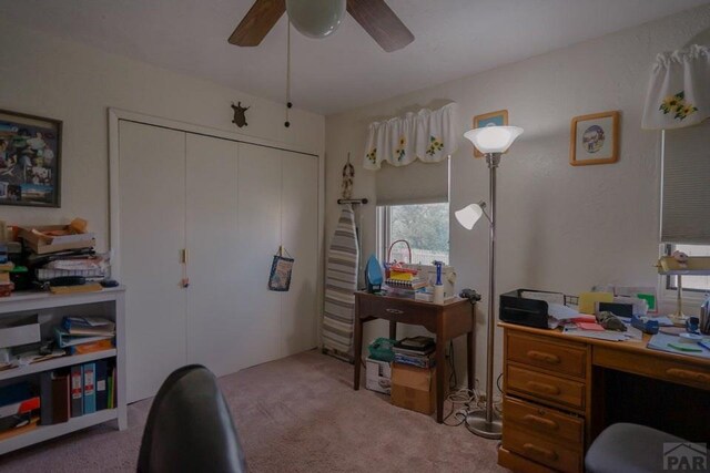 carpeted office featuring a ceiling fan